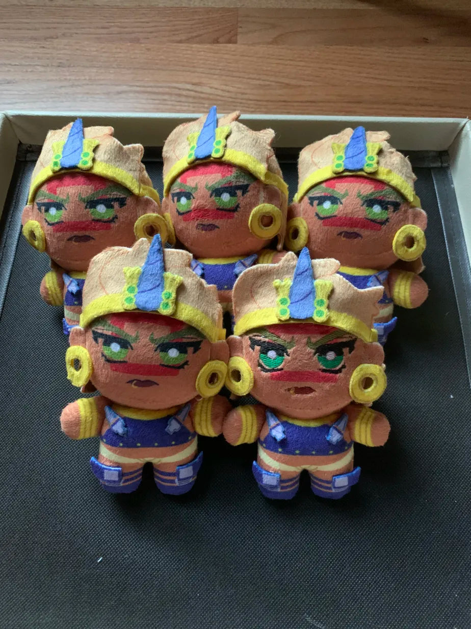 Five plush toys with golden jewelry and red square face markings
