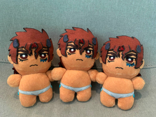 Three plush toys with red hair and angry frowns on a grey background